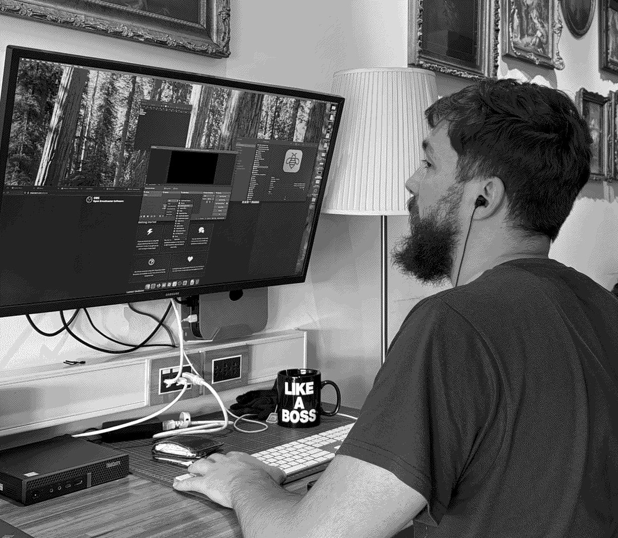 an individual looking at a terminal window on a laptop, sitting by a pcb and a soldering iron